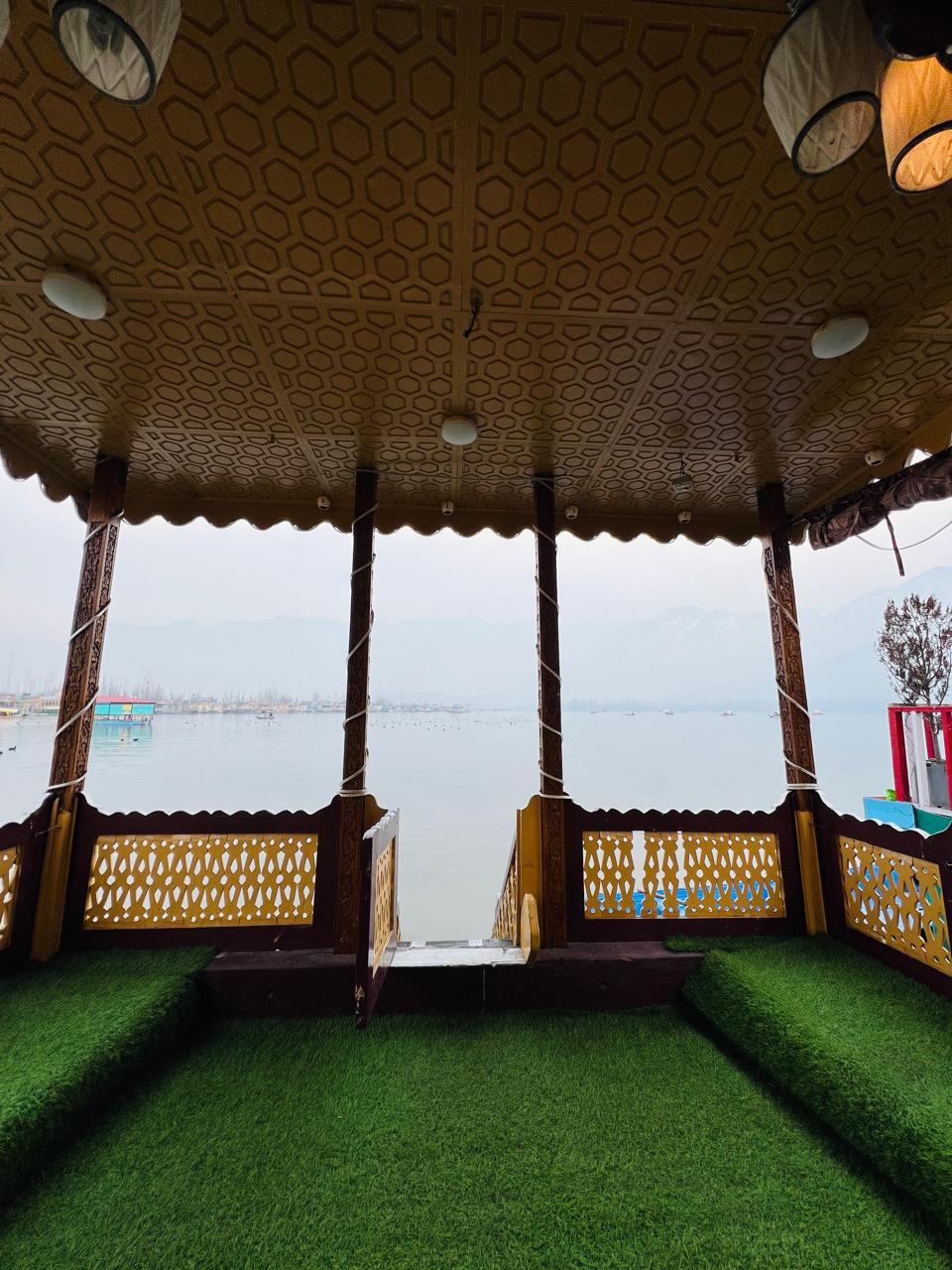 Houseboat deck with carved wooden pillars and open lake view