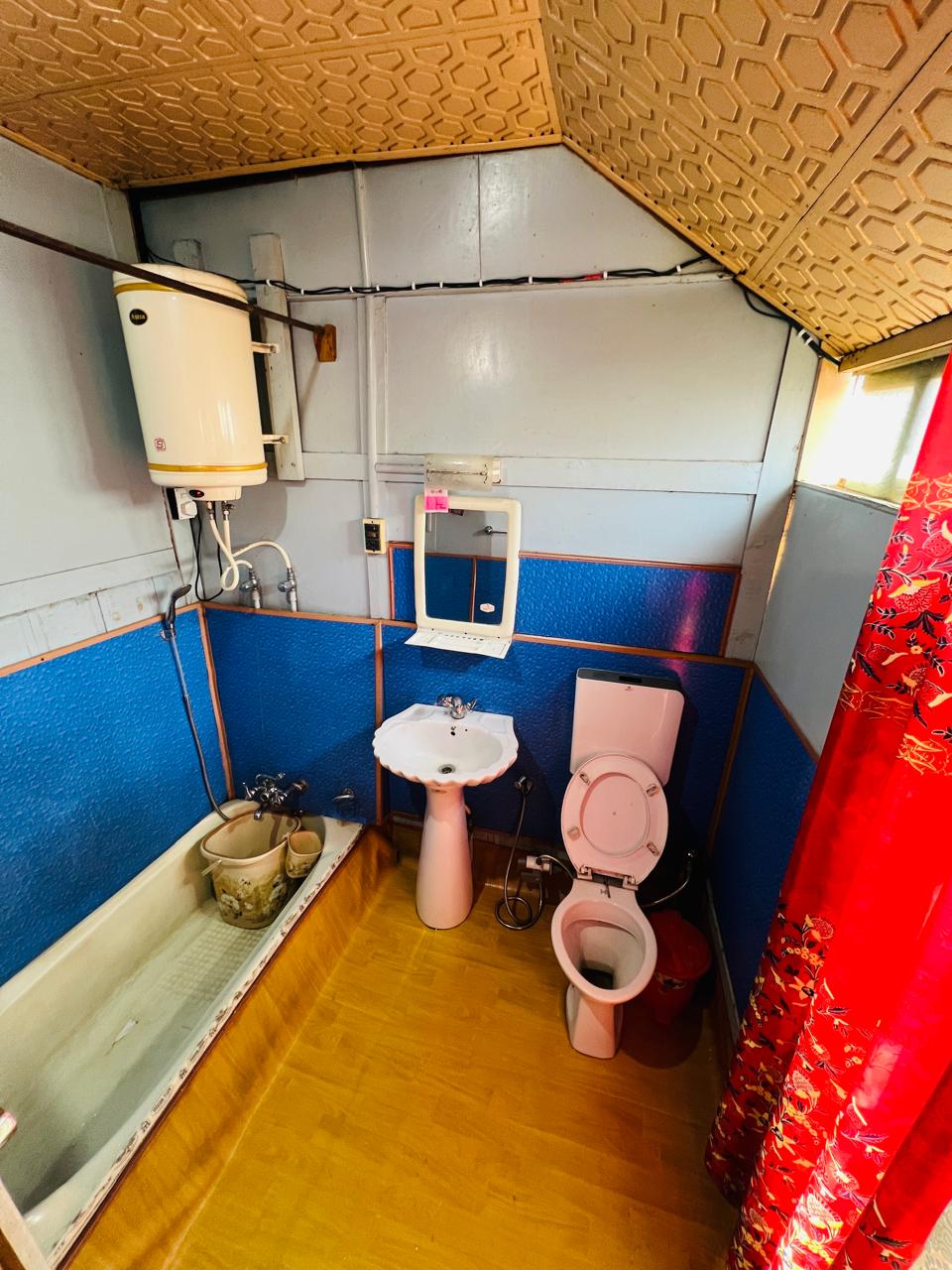 En-suite bathroom with geyser and bathtub