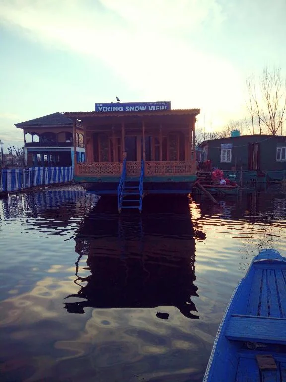 The houseboat and its deck reflected on the lake at dusk